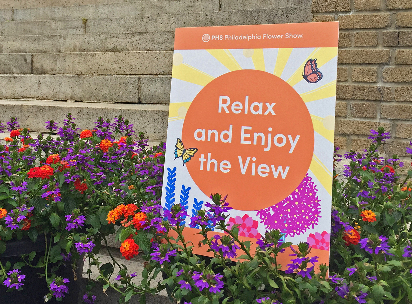 Signage to encourage enjoying the view from the Boathouse outdoor restaurant at the 2021 PHS Philadelphia Flower Show.